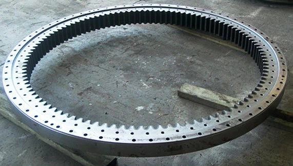 Large diameter internal toothed slew bearing gear ring laid out on the workshop floor